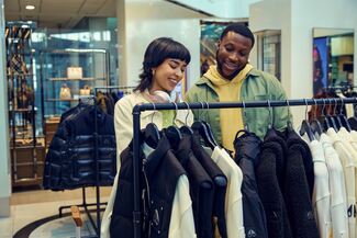 Two people shop for clothing